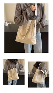Macro view of cream canvas tote bag showing multiple pockets and durable stitching