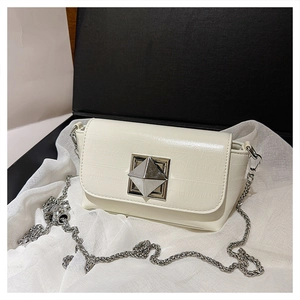 Detail of creamy white crossbody bag with silver geometric buckle and chain strap