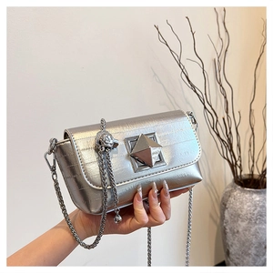 Detail showing metallic silver square bag with crocodile texture and diamond lock