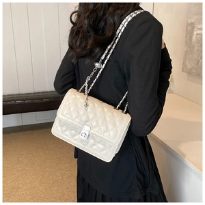 Detail of quilted beige leather bag with adjustable silver chain and metal ball lock