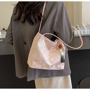 Detailed embroidery of Chinese pavilions and trees on a pink jacquard silk tote bag