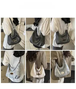 Multiple views of women's denim hobo bag with adjustable strap and chain detail