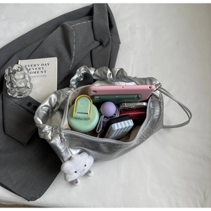 Macro shot of large silver tote bag interior showing capacity for tablets and daily items