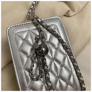 Detailed close-up of quilted leather card bag with silver metal chain and adjustable bead