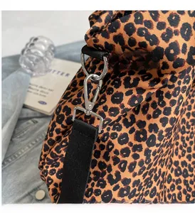 Dettaglio macro della borsa in tela leopardata con ganci metallici argentati pregiati