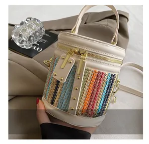 Detailed close-up of smooth dual zippers and colorful woven texture on bucket bag