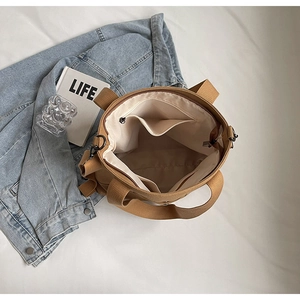 Internal view of khaki canvas tote showing zippered pocket and spacious inner lining