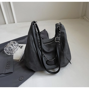 Detailansicht der anthrazitfarbenen Jeans-Tasche mit Ledergriffen und Silberkette