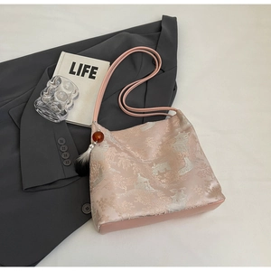 Detailed embroidery of Chinese style tote bag with silk texture and beaded tassel