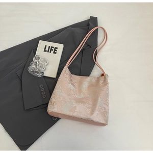 Detailed view of pink jacquard tote bag with traditional Chinese embroidery and leather straps