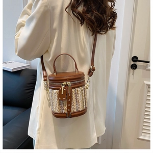Rear view of a model wearing the woven bucket bag in a cozy minimalist indoor setting