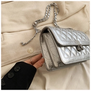 Silver metallic crossbody bag featuring quilted rhombus patterns and tiered side gussets