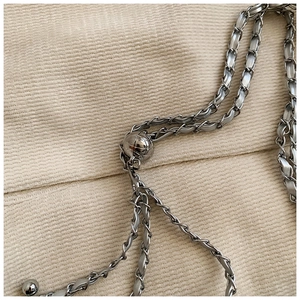 Detail of adjustable metal gold ball buckle on leather interwoven chain strap