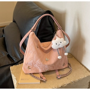 Borsa a spalla rosa testurizzata con farfalle d'argento e ciondolo a nuvola soffice