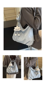 Détail du sac fourre-tout plissé bleu clair avec breloque nuage et logo Muon Shark