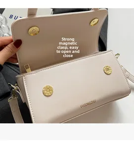 Detailed interior of contrast crossbody bag featuring dual gold magnetic snap buttons