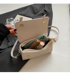 Detail view of the open interior compartments in a beige crossbody flap bag