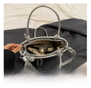 Internal view of silver bucket bag showing large storage capacity for cosmetics and phone