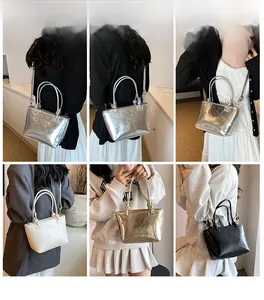 Detail view of stylish bucket bags in metallic silver, gold, black, and cream colors