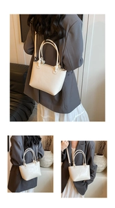 Detail of white leather bucket bag showing textured finish and knotted handle design