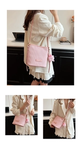 Close-up of pink pleated leather bucket bag featuring fashion label and plush charm detail