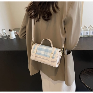 Detailed back view of a contrast color checkered crossbody bag worn with a stylish blazer