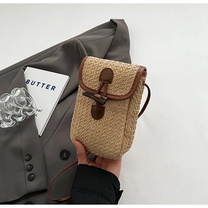 Mini straw woven crossbody bag with brown faux leather trim and horn button closure detail