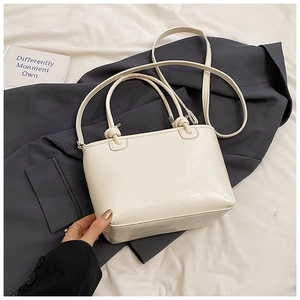 Chic cream white bucket bag with wrinkled texture finish and slim crossbody strap