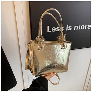 Detail of knot handle and vintage metallic texture on this golden bucket tote bag