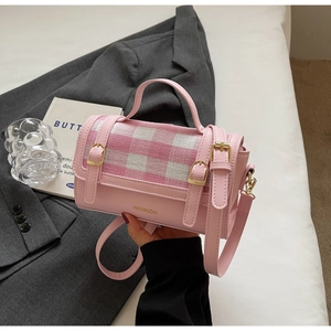 Detail view of pink plaid crossbody bag with VVGONGZHU logo and leather straps