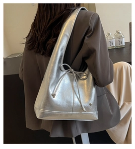 Detail of silver metallic wrinkled leather tote bag with slender bow and stitching