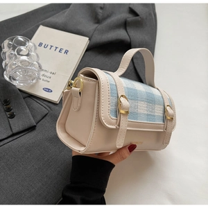 Detail of checkered crossbody bag with gold hardware and elegant brand lettering