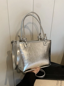 Silver metallic bucket bag with pleated texture and adjustable strap for women