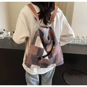 Detail of wide strap multi-use denim tote backpack with patchwork design and metal zipper
