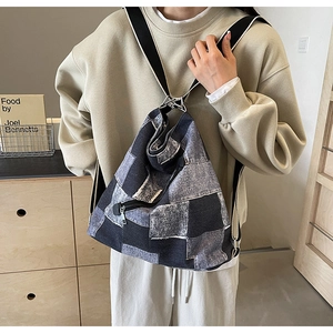 Detailed close-up of patchwork denim fabric and silver zipper on the versatile backpack