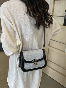 Light blue denim saddle bag with contrast trim and gold rabbit twist lock for women