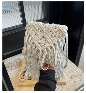 Detail of bohemian handmade macrame woven bag featuring intricate knots and long tassels