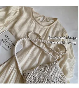 Detail of bohemian cream woven straw bag with handmade rope knot strap and tassel