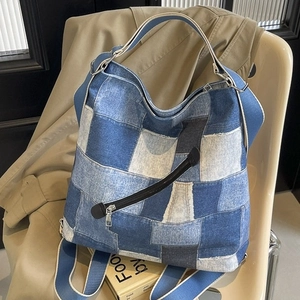 Blue denim patchwork tote bag with wide strap and decorative zippers for women