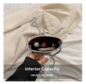 Interior view of silver chain bucket bag showing capacity for lipstick and makeup compact