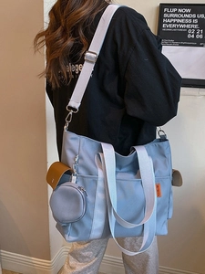 Large light blue nylon tote bag with wide strap and side coin pouch in casual style