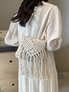 Handmade bohemian macramé straw shoulder bag with long tassels for beach vacation