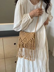 Bohemian woven straw crossbody bag with geometric patterns and long fringe tassels