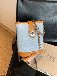 Blue denim and brown leather bucket bag with chain strap and silver twist lock detail