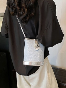 Light blue denim bucket bag with silver trim and metal chain strap for women