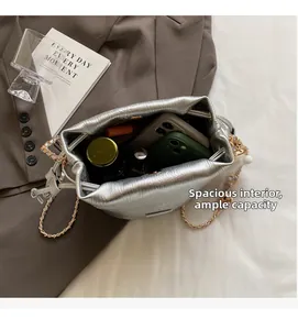 Top view of silver drawstring bucket bag showing large interior capacity for phone and cosmetics