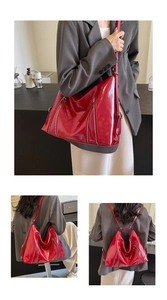 Detail of red glossy patent leather bow backpack showing dual-use shoulder strap style
