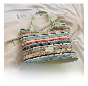 Detail of colorful woven tote bag with striped pattern on soft white bedding background