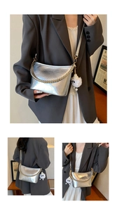 Detail of silver metallic shoulder bag with gold chain and plush charm accessory