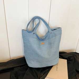 Large capacity light blue denim tote bag with brown leather label and dual straps